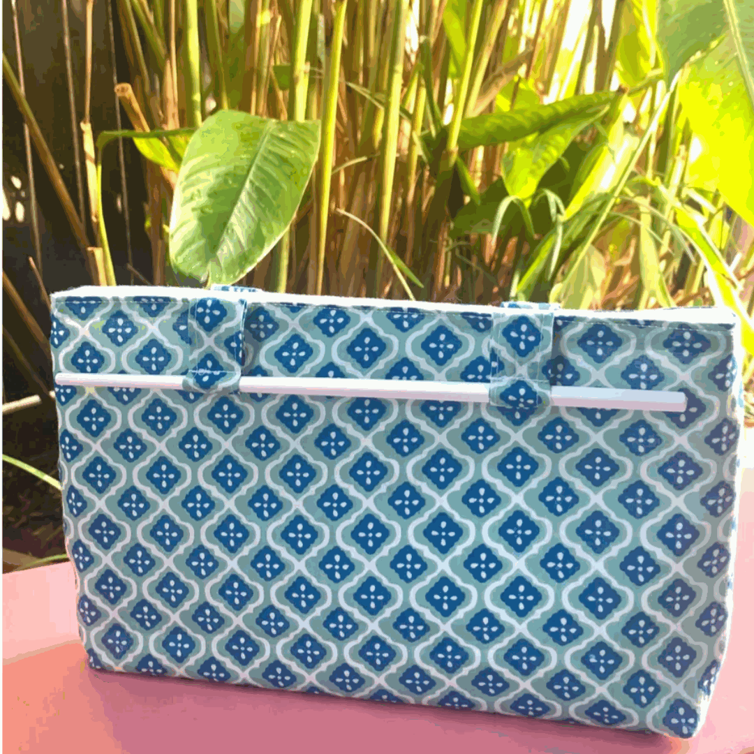 Noosa Escape Chopstick Handle Clutch Bag with blue and sea green block-printed fabric and white chopstick handles