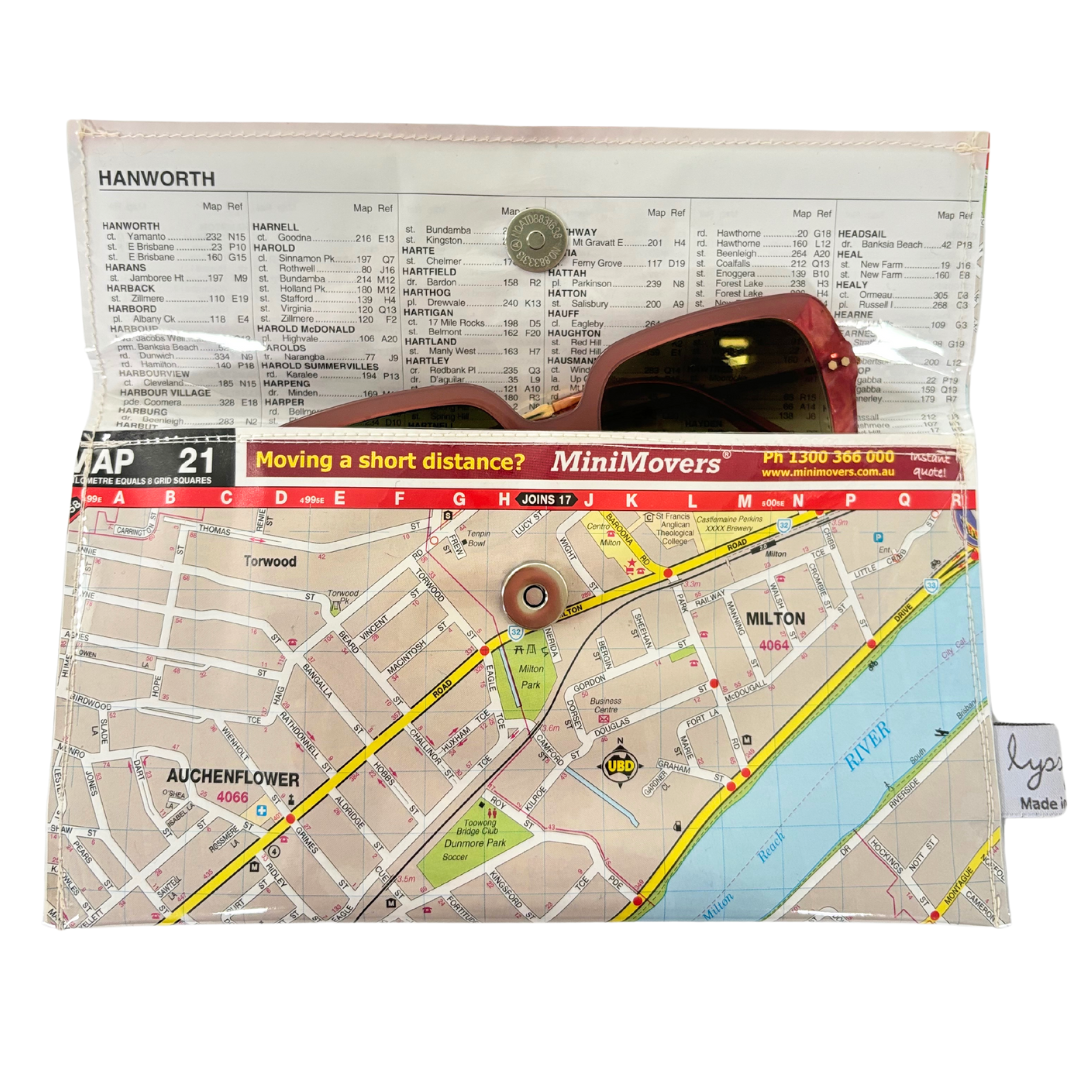 A PVC-covered wallet with a printed street map design, open to show the internal lining and a magnetic clip closure.