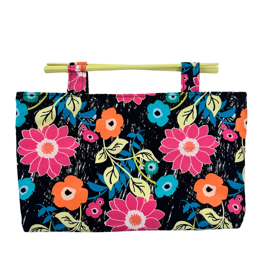 Handmade clutch design made with chopsticks for handles. This floral fabric design is lightweight and has been treated with fabric protector.