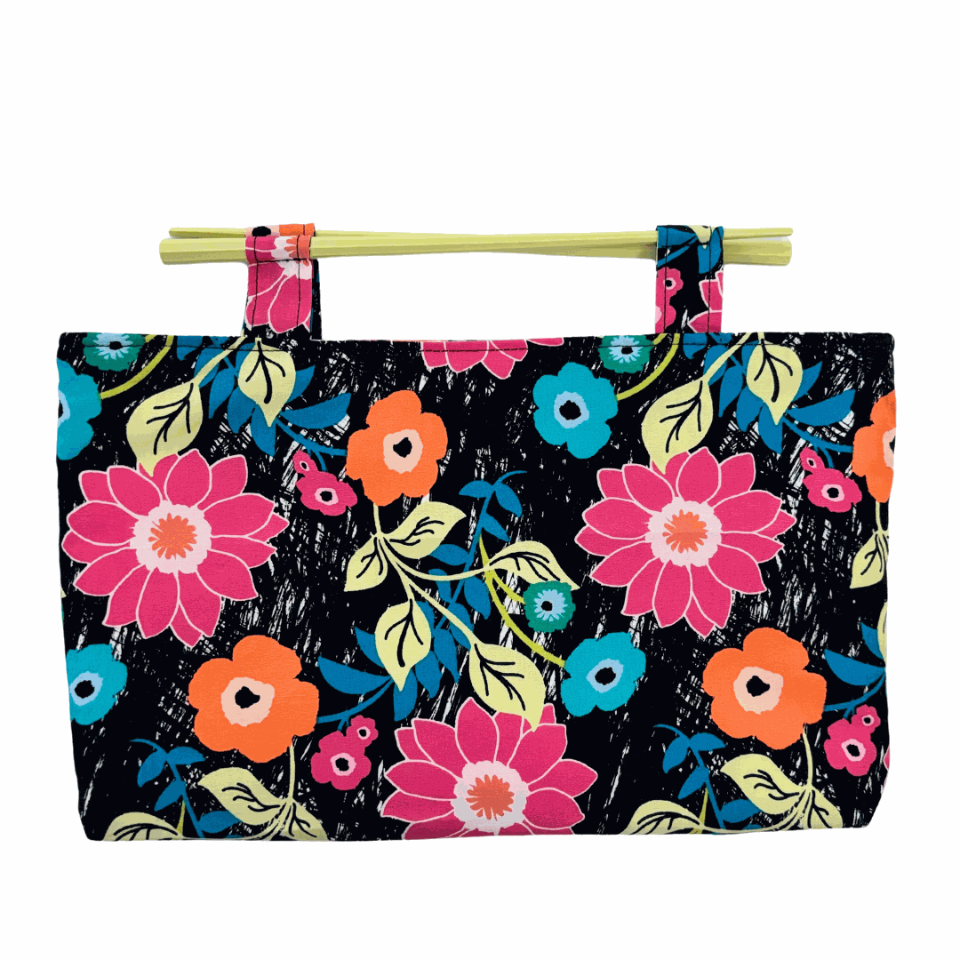 Party in the Jungle floral cotton clutch bag with pastel yellow resin chopstick handles and magnetic clasp closure