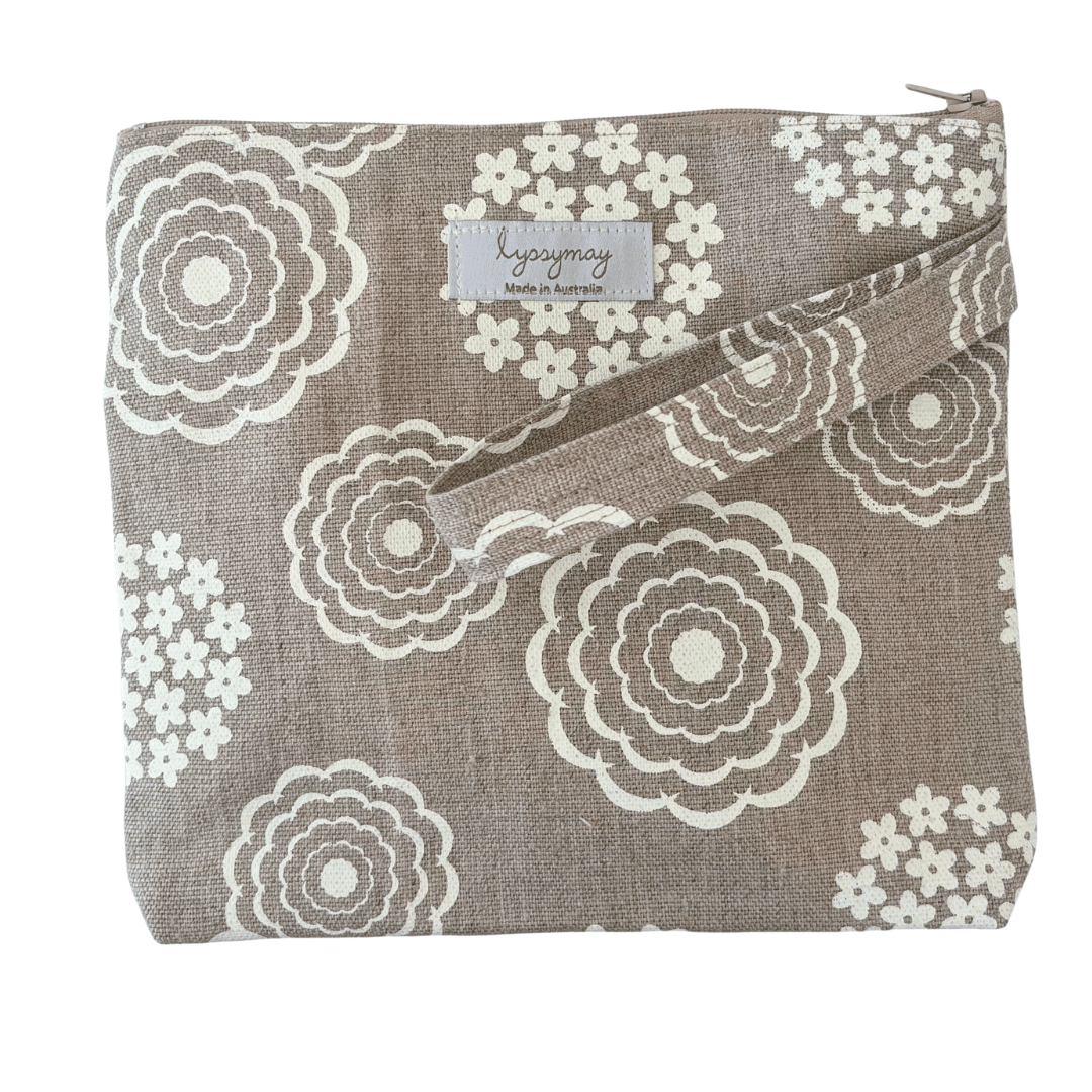 Floral patterned pouch with a lyssymay brand label on a white background