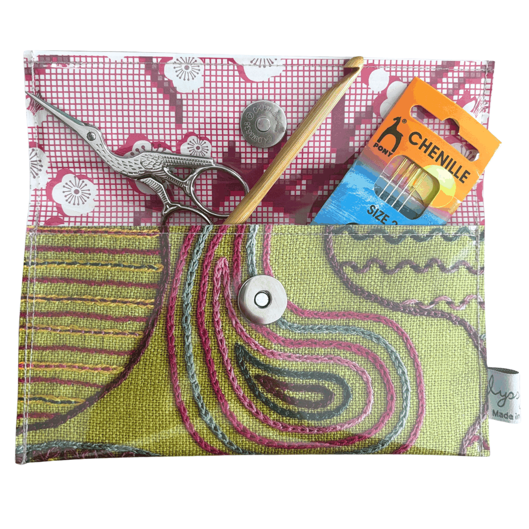 Vintage 1950's magazine wallet with colorful embroidery stitches on green linen and floral paper lining
