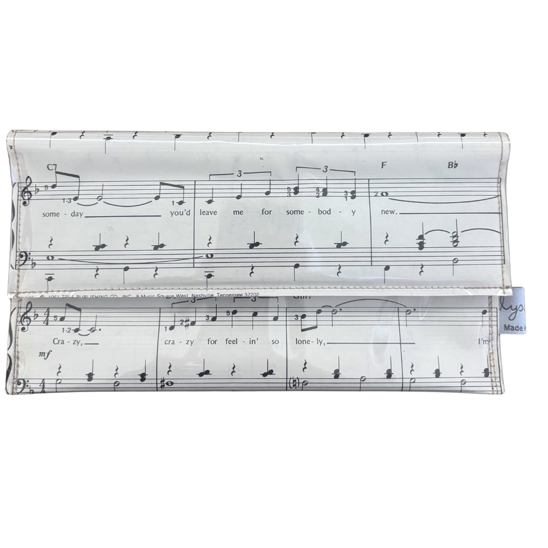 handmade wallet with music sheet design on a white background