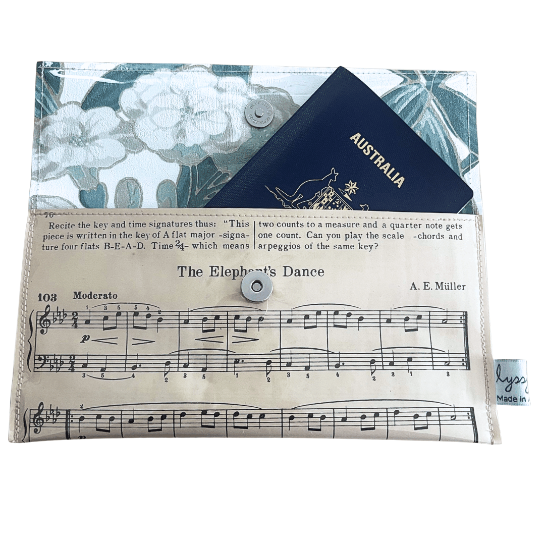 Vintage sheet music wallet made from 1940s piano book page featuring musical notes and botanical wallpaper lining