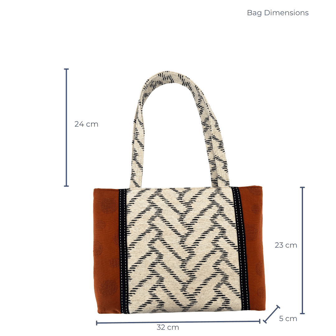 Close-up of burnt toffee Japanese cotton panel with woven chevron strap detail on handcrafted shoulder bag – Lyssy May. Dimensions of bag 32 cm wide by 23 cm high