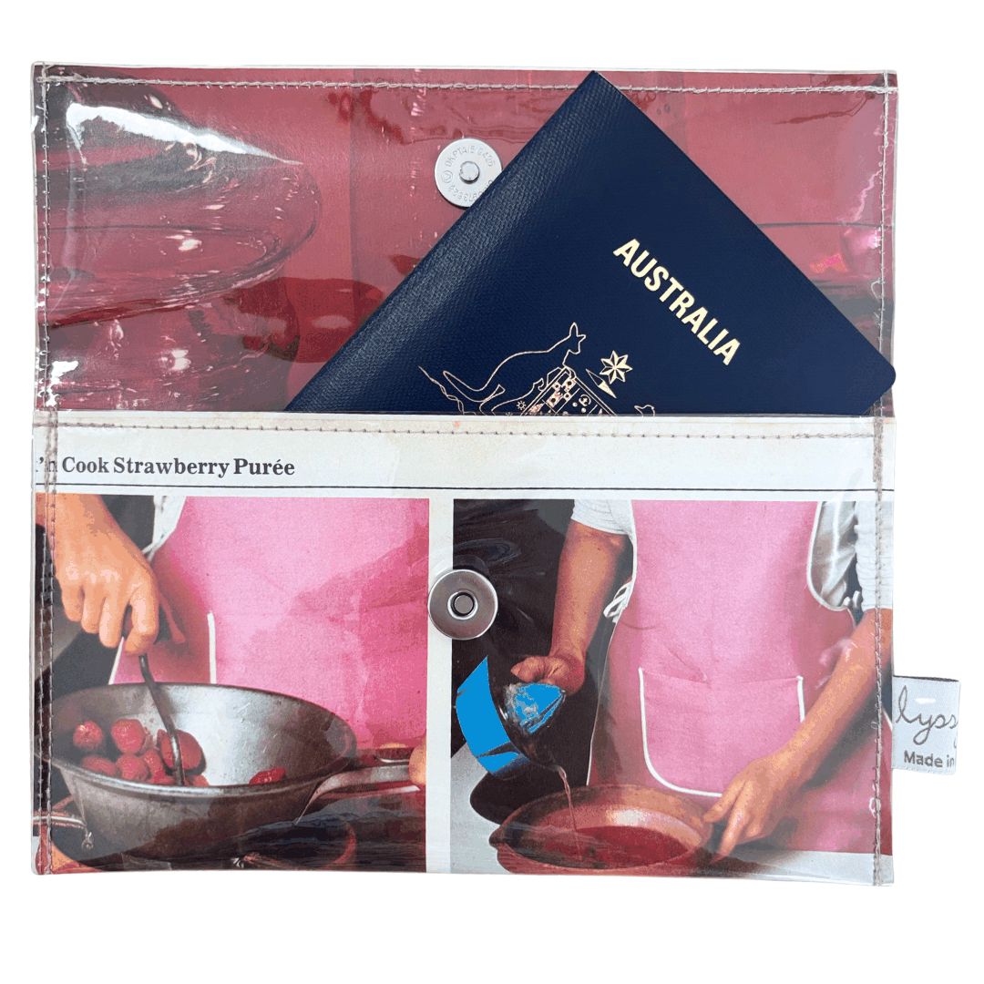 Wallet with images of cooking activities using a retro recipe book that can hold a passport as pictured