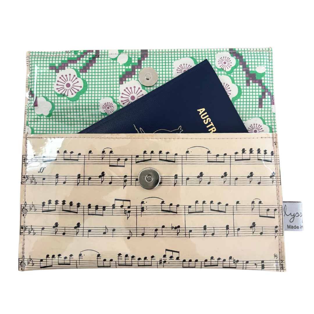 Multifunctional pouch with floral pattern, music sheet design, and Australian passport inside.
