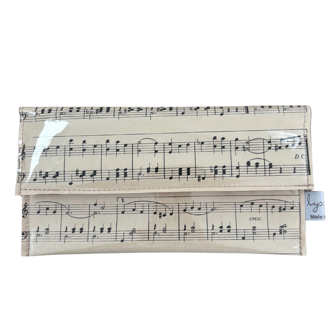 Clutch wallet with music sheet design on a white background