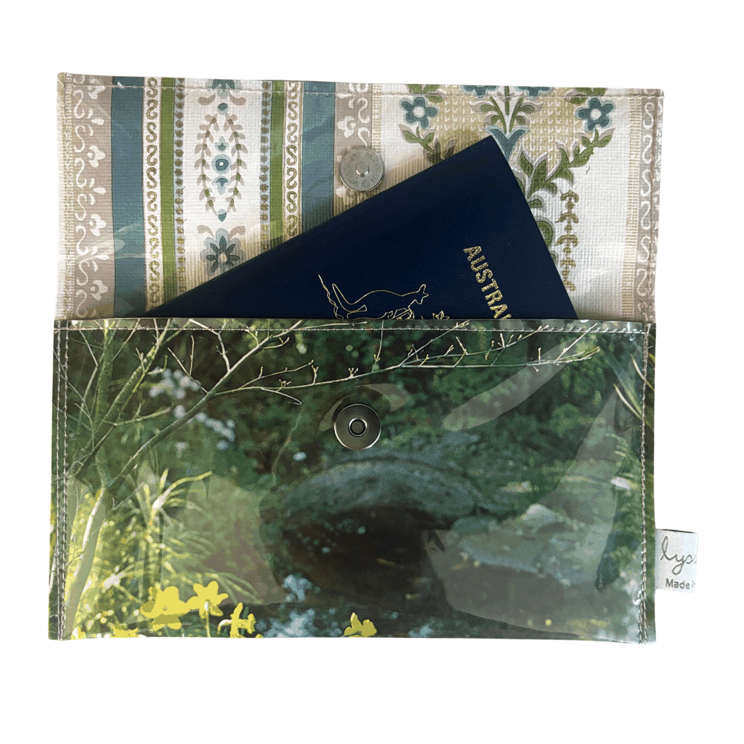 Passport holder with nature-themed design featuring a water and plants