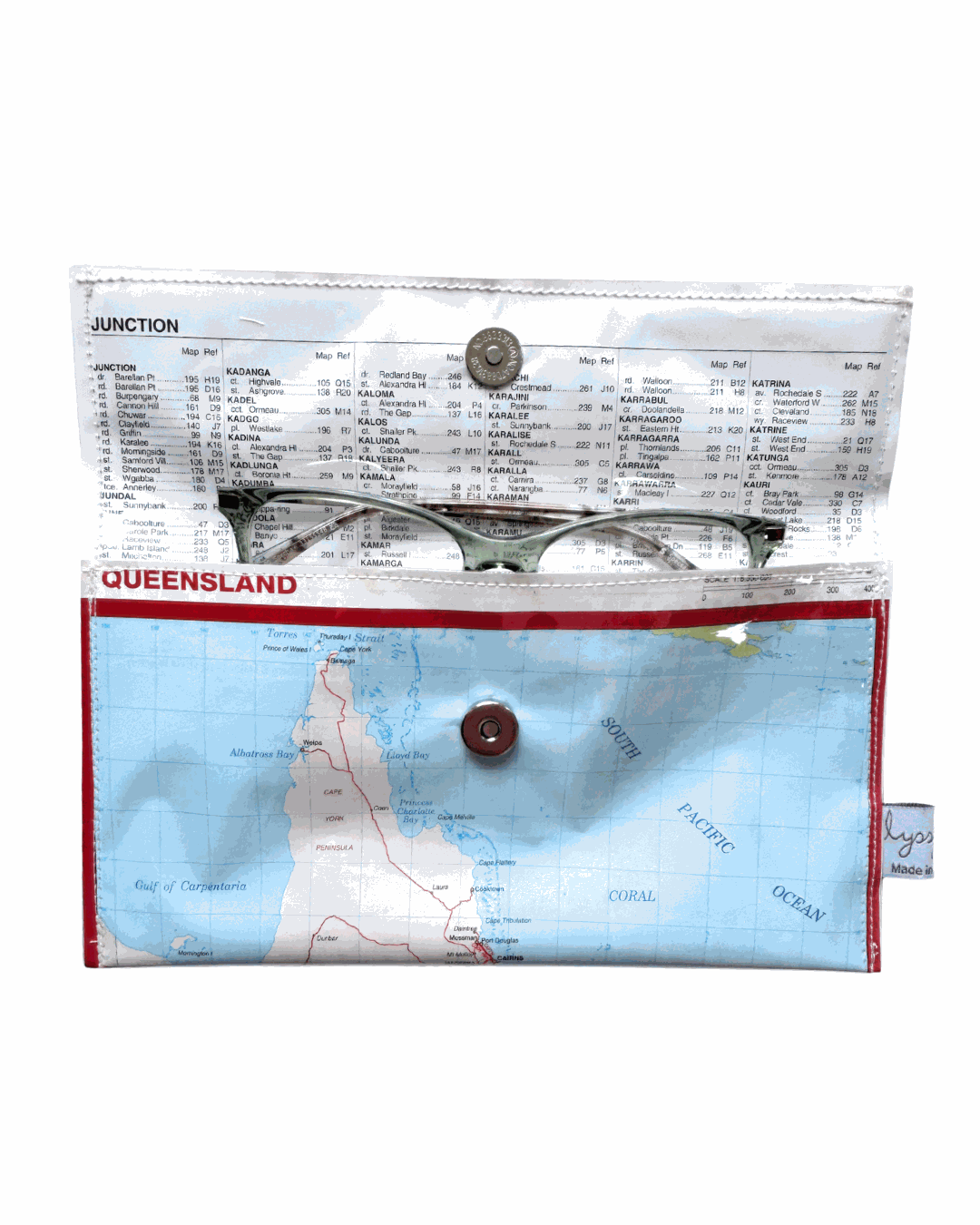 Lyssy May recycled map wallet of Queenslands. Inside view of wallet with index page lining and magnetic clip closure. Pair of eye glasses inside the wallet.