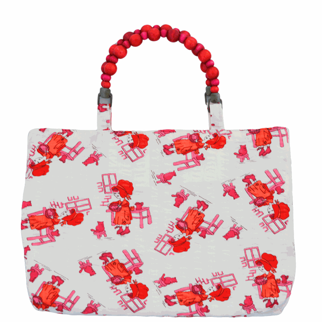 Beaded handle bag with red and pink pattern on a white background