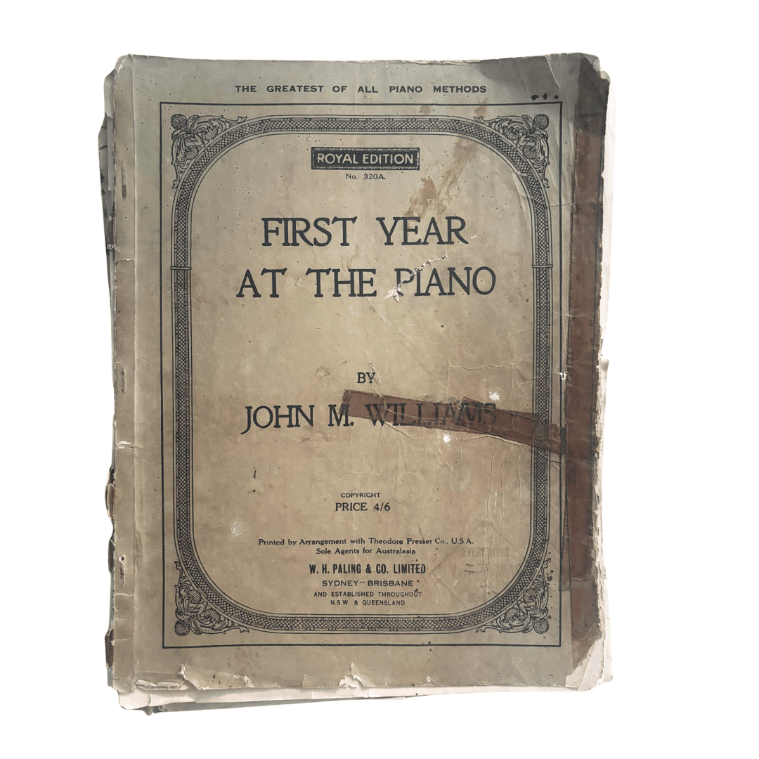 Vintage book titled 'First Year at the Piano' by John M. Williams on a white background used to create Lyssy May's sheet music wallet
