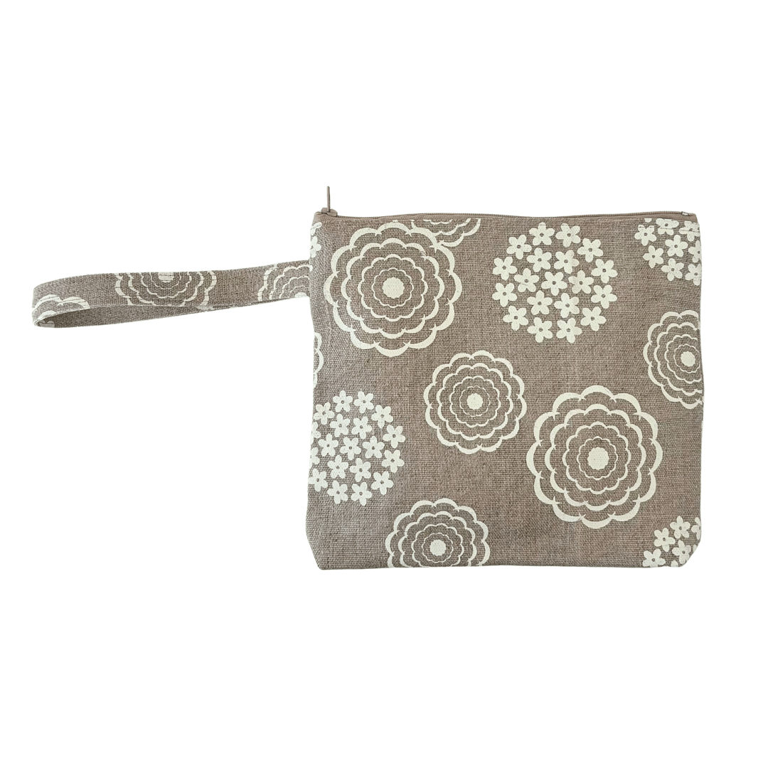 Floral patterned pouch with wrist strap on a white background