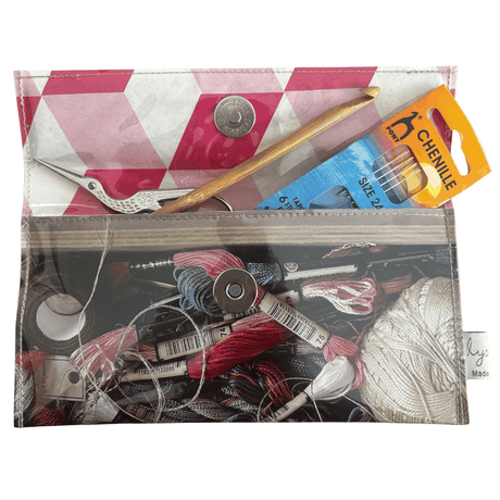 Vintage 1950's magazine wallet featuring embroidery threads and ribbons with geometric pink lining and magnetic clasp