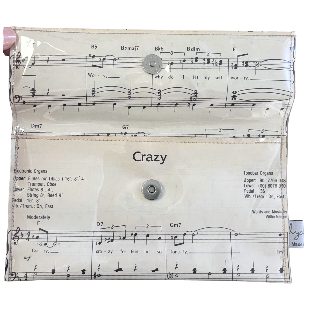 Wallet made from with music sheet design and 'Crazy' text on a white background
