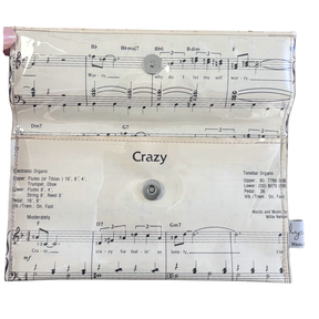 Wallet made from with music sheet design and 'Crazy' text on a white background