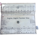 Clear handmade wallet with music sheet design and text 'Engine, Engine Number Nine' on a white background