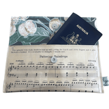 Vintage sheet music wallet made from 1940s piano lesson book page featuring "Pattering Raindrops" and "Crossing the Bridge" with floral wallpaper lining and magnetic clasp