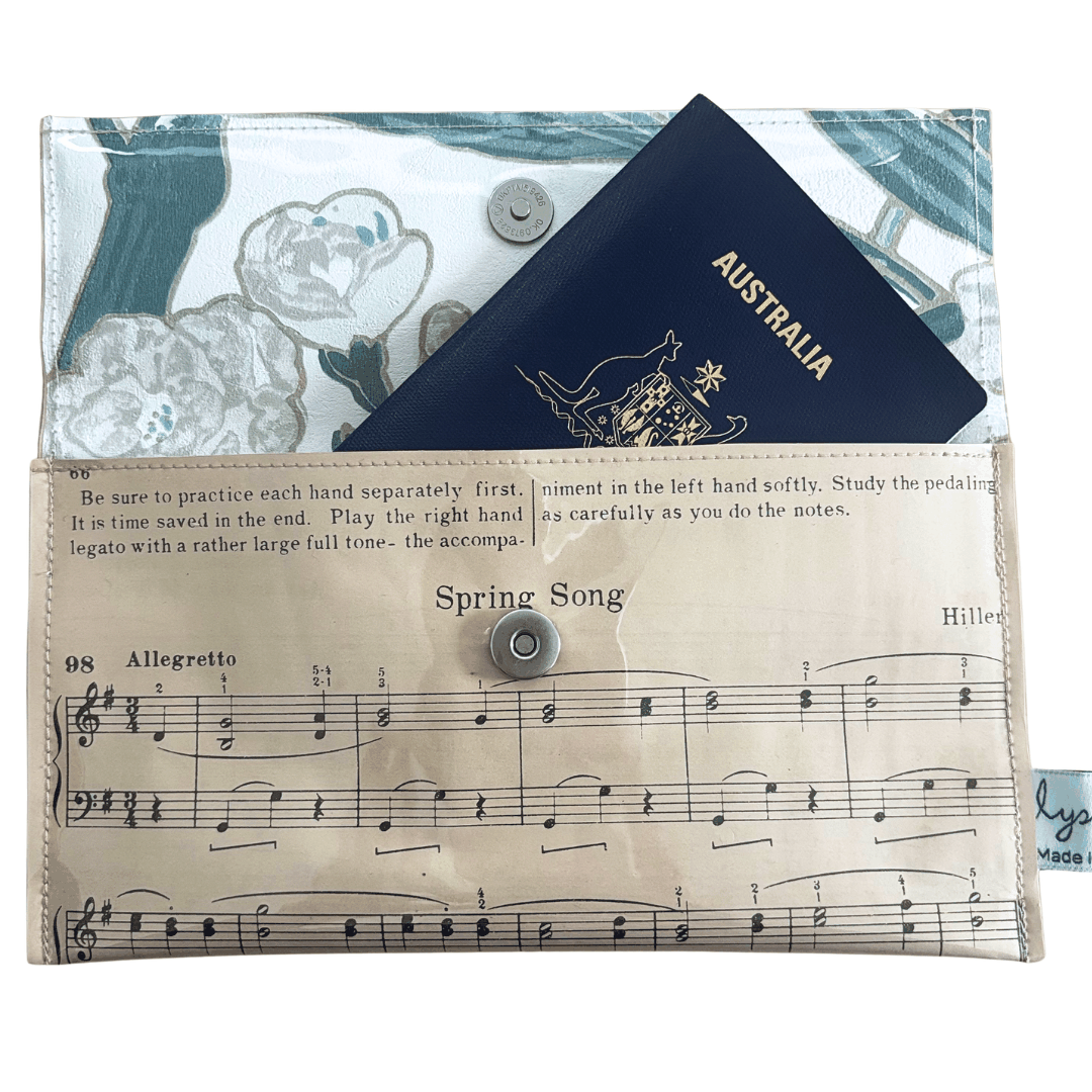 Vintage sheet music wallet handcrafted from 1940s piano lesson book page featuring Spring Song and Evening Song with floral wallpaper lining
