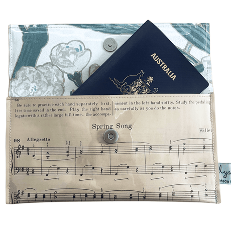 Vintage sheet music wallet handcrafted from 1940s piano lesson book page featuring Spring Song and Evening Song with floral wallpaper lining