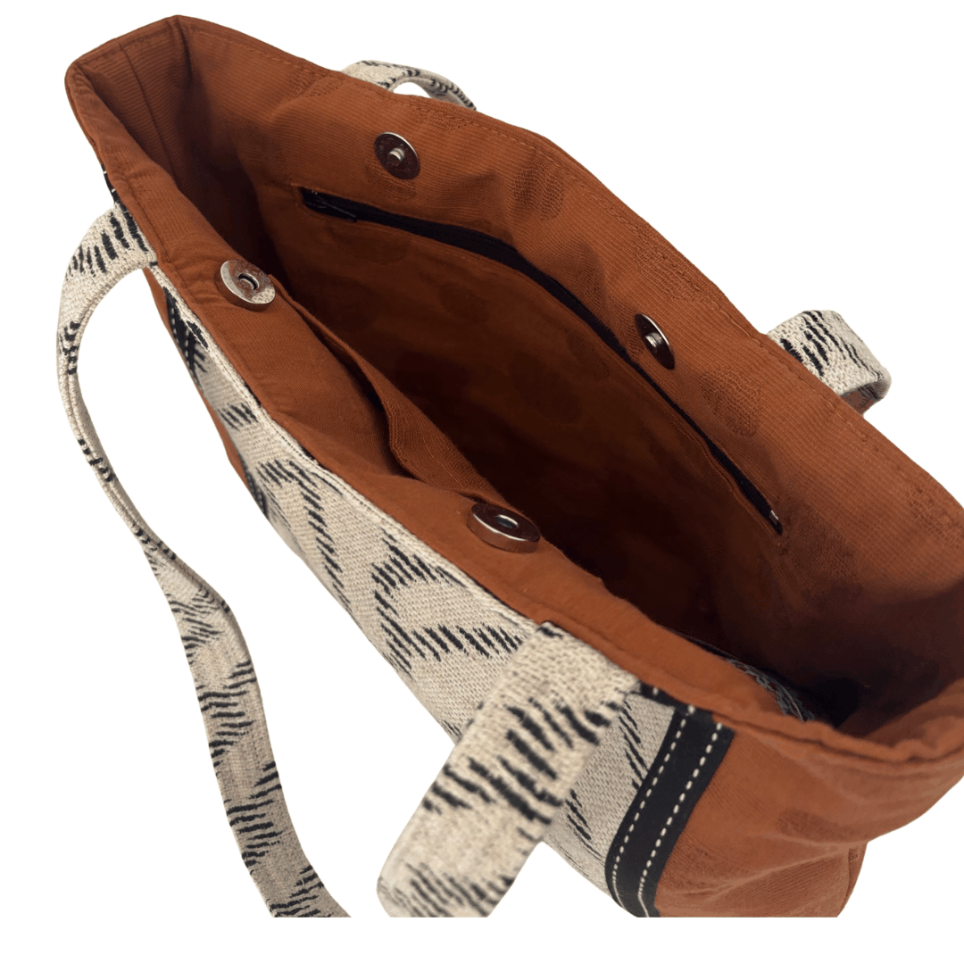 Interior of Burnt Caramel Noir tote showing burnt toffee lining, internal zip pocket and open pocket with magnetic clasp closure – Lyssy May