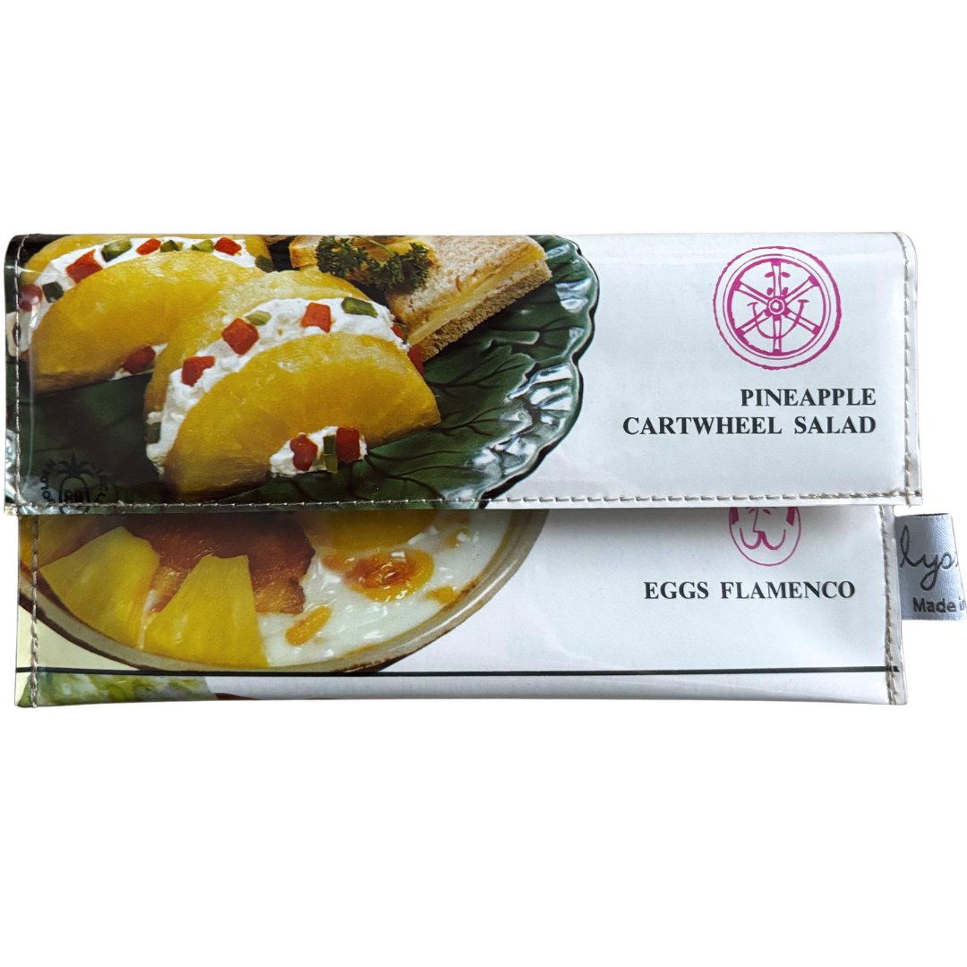 Wallet with pineapple cartwheel salad design on a white background