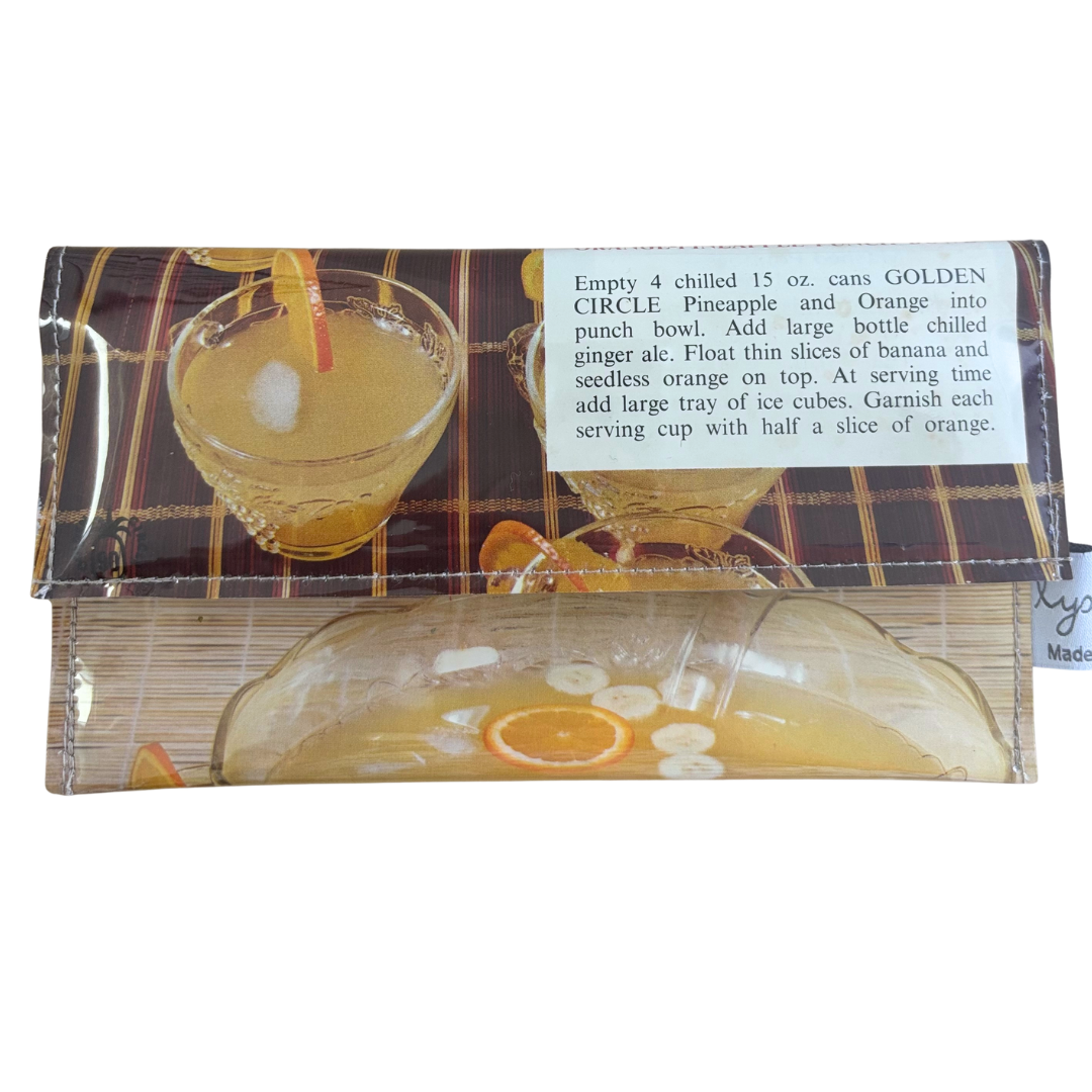 Handmade wallet featuring glasses of punch and  punch recipe instructions on a white background