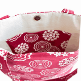 Close-up of inside pocket of LyssyMay handprinted fabric bag with red and white floral pattern