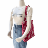 Mannequin wearing LyssyMay Cottage garden tote over shoulder with tshirt and denim skirt
