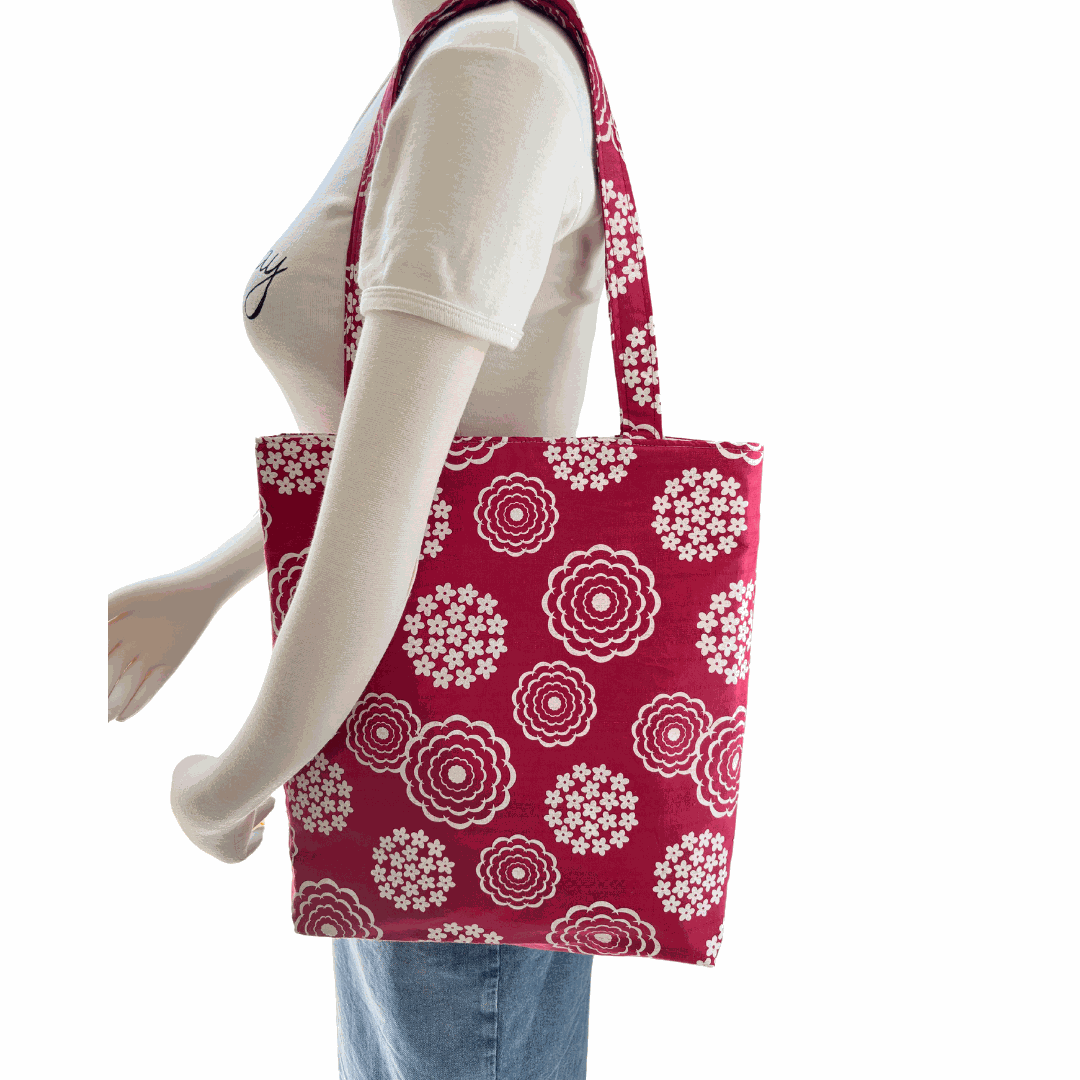 Mannequin wearing Lyssy May tote bag featuring white floral patterns on a white background