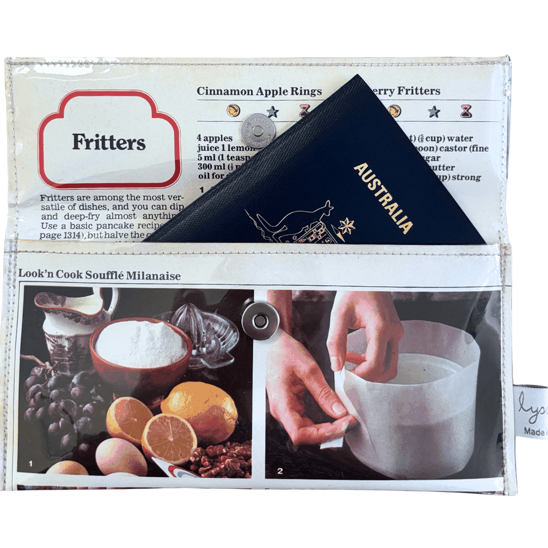 Retro recipe wallet made from 1970s cookbook pages featuring Souffle and Fritters recipes with lemon, grapes, eggs, and cinnamon apple rings designs.
