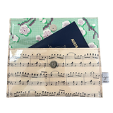 Multifunctional pouch with floral pattern, music sheet design, and Australian passport inside.