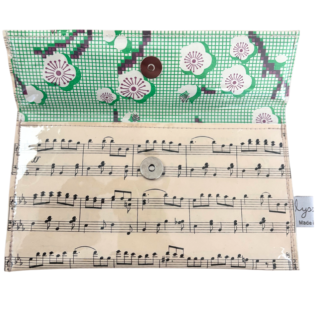 Pouch with musical sheet design and floral pattern on flap