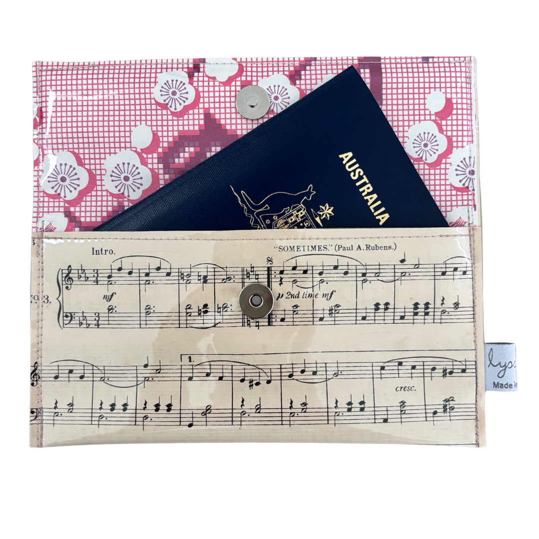 Passport holder with floral pattern on top and sheet music design at the bottom