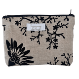 Fabric pouch with black floral pattern on beige background, featuring lyssymay brand label.