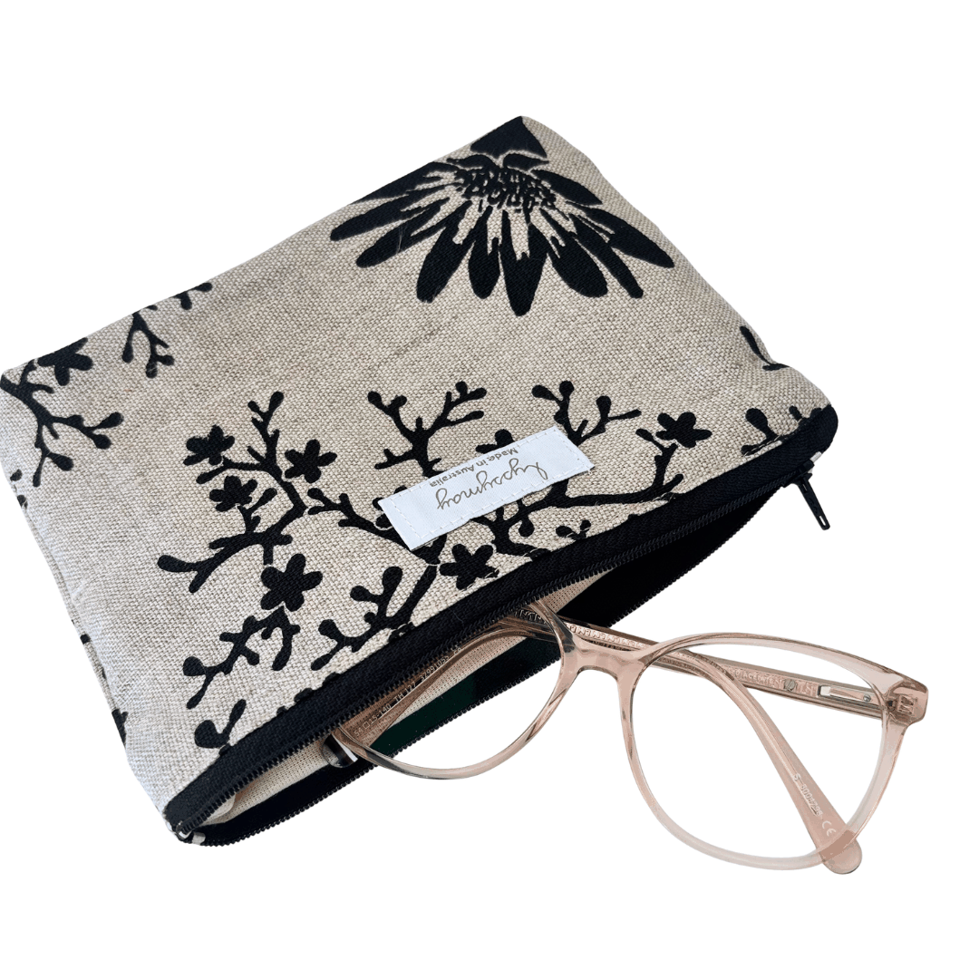 Floral-patterned pouch with a pair of glasses on a white background