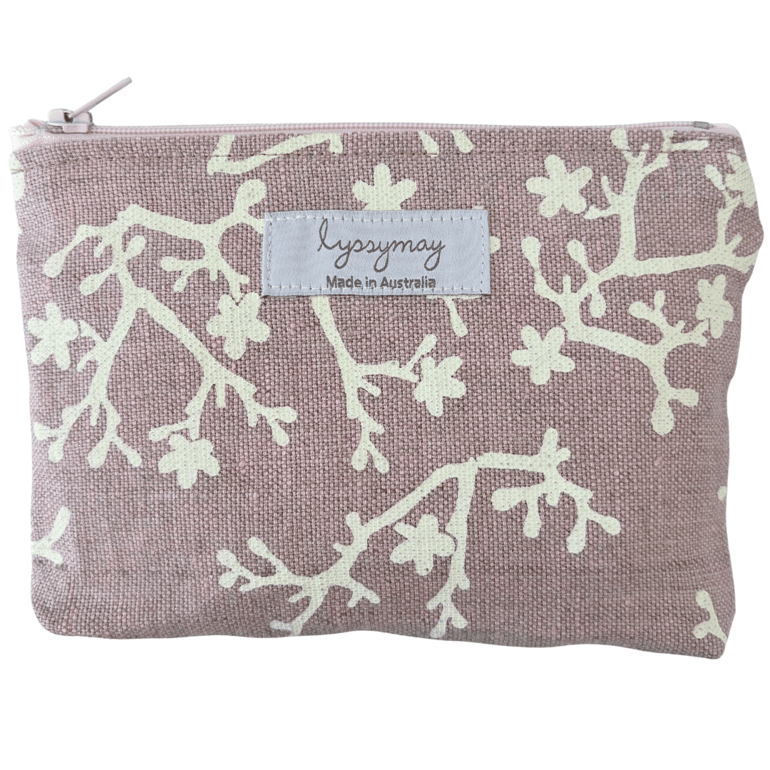 Fabric pouch with white floral pattern and 'lyssymay' label on mauve linen