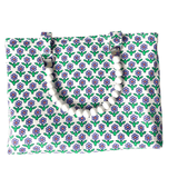 Floral patterned bag with a white beaded handle on a white background