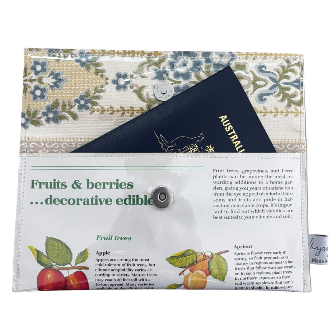 Floral-patterned wallet with text and fruit illustrations on a white background