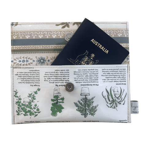 Lyssy May handmade wallet featuring pages from a vintage gardening book. Inside view showing that a passport fits inside. Magnetic clip closure.