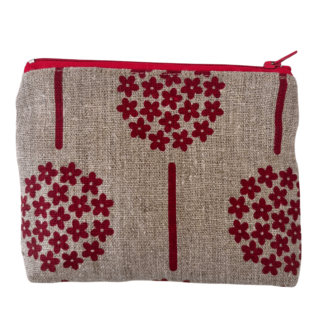 Fabric pouch with red floral patterns on a natural linen background