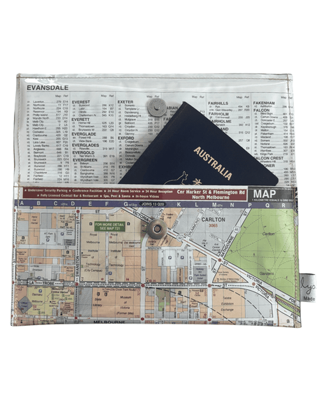 Inside view of handmade map wallet featuring Melbourne by Lyssy May Australia that is lined with an index page and closes with magnetic clip. A passport fits in the wallet